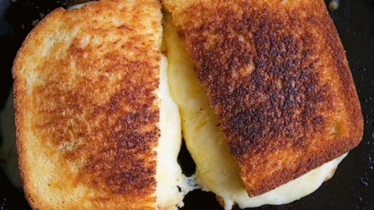 Classic grilled cheese sandwich made with artisan cheese and golden toasted bread, delivering a simple yet irresistibly creamy comfort food favorite.