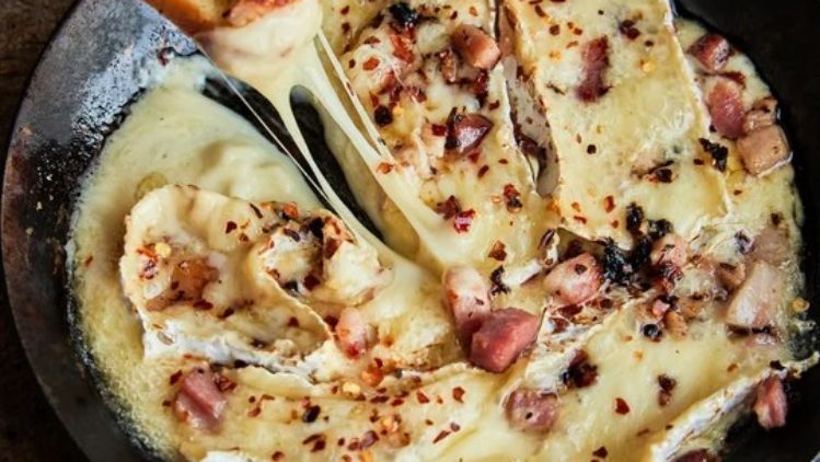 Baked Devil’s Gulch cheese with crispy pancetta and red pepper flakes, served warm for dipping with toasted baguette slices.