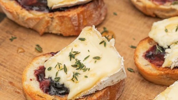 Toasted crostini topped with creamy Mt Tam triple cream cheese and sweet marionberry preserves, finished with fresh thyme for an elegant appetizer.