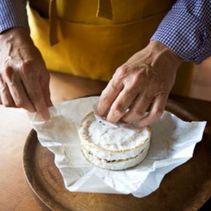 Layered Mt Tam or Camembert cheese wrapped and resting, allowing the truffle or wild mushroom filling to infuse rich, earthy flavors throughout