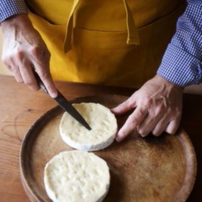 Creamy Mt Tam or Camembert cheese layered with aromatic truffles or wild mushrooms, creating an elegant gourmet appetizer.