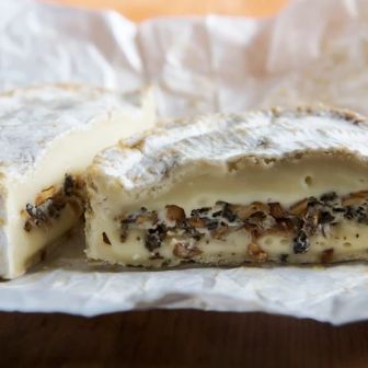 Mt Tam or Camembert layered with truffles or wild mushrooms, revealing a creamy interior infused with rich, earthy flavors.