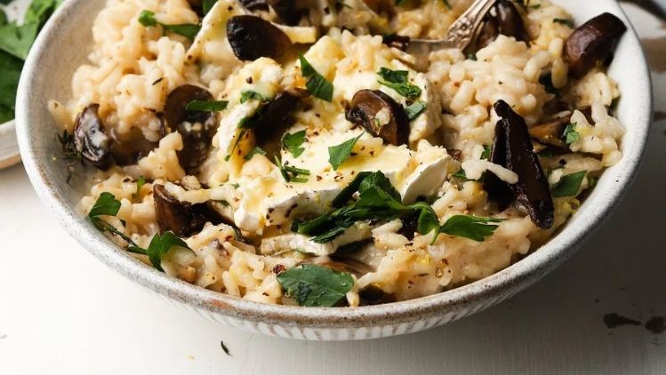 Creamy mushroom risotto with Mt Tam triple cream cheese, fresh herbs, and sautéed seasonal mushrooms for a rich and comforting gourmet meal.