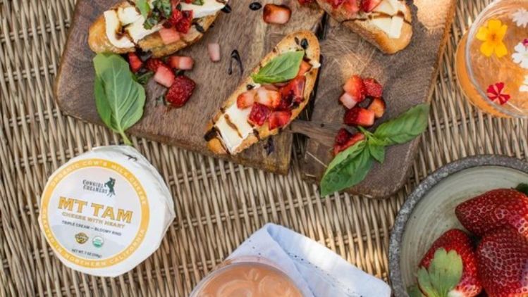 Strawberry bruschetta with Mt Tam triple cream cheese, fresh basil, and balsamic glaze served on toasted bread for a vibrant sweet-and-savory appetizer.